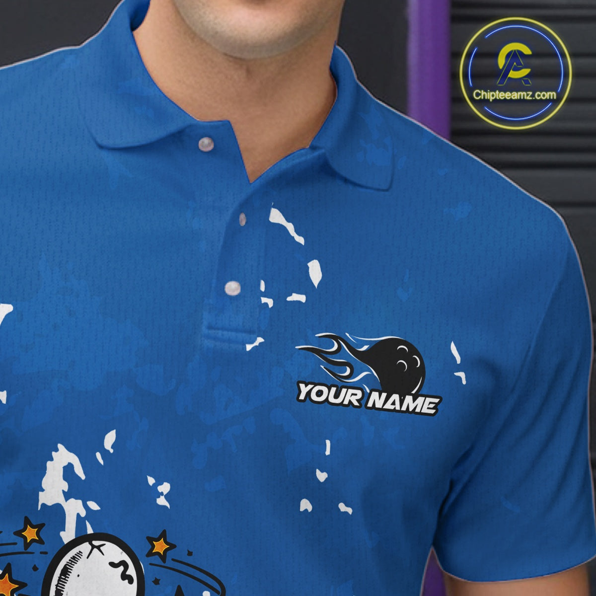 Close-up view of left chest area of a blue and white polo shirt, showing small detailed drunk bowling pin graphic with beer bottle and bowling ball.