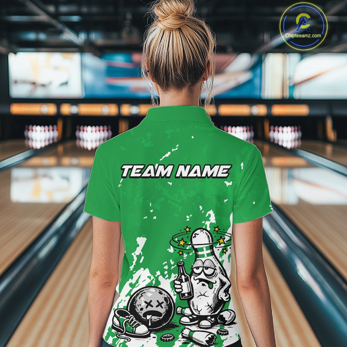 Back view of a female bowler wearing a green and white polo shirt, splatter-style drunk bowling pin illustration holding beer bottle and bowling ball.