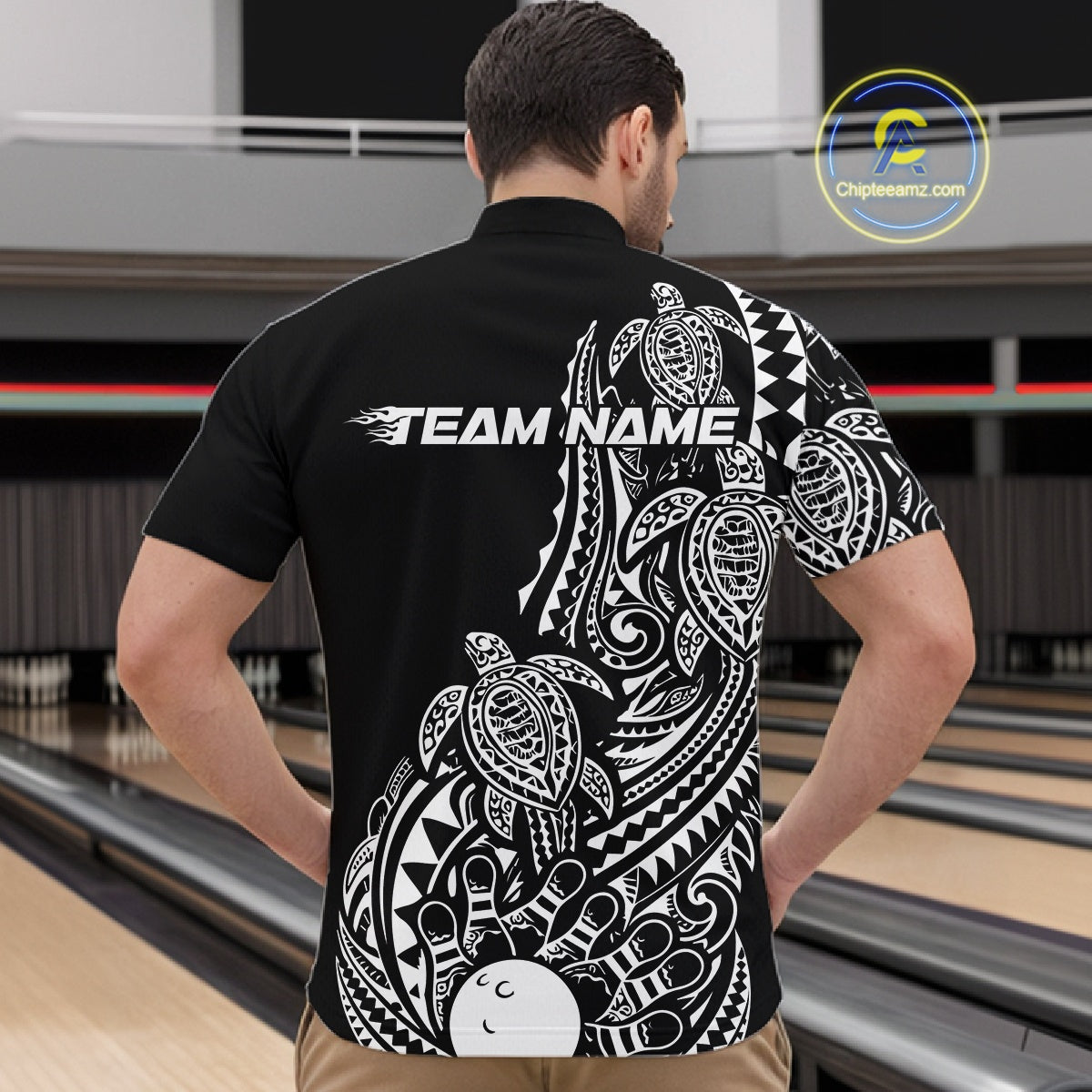 Front view of a male model in a black and white bowling quarter-zip shirt displaying tribal swirl bowling artwork.