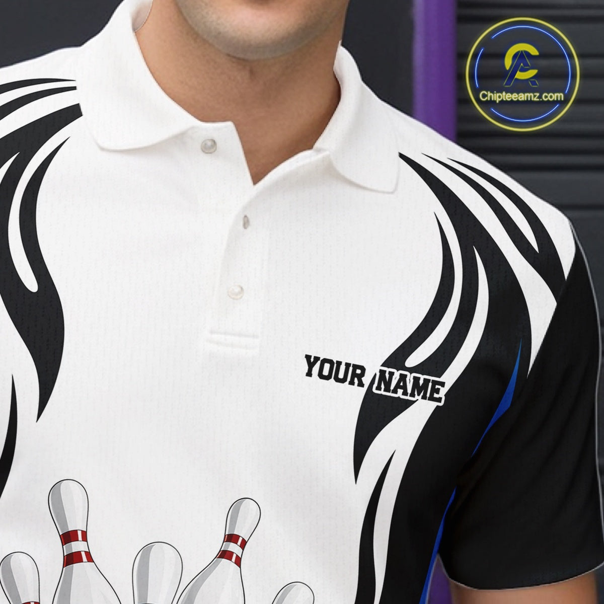 Close-up of the left chest on a white, black, and blue bowling polo shirt featuring bowling ball and pins graphics.
