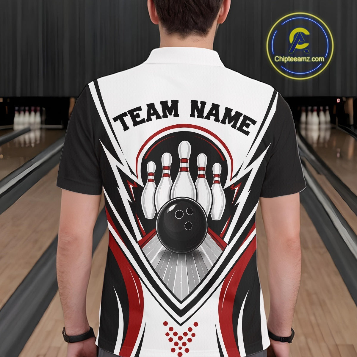 Back view of a male model at a bowling lane wearing a white, black, and red bowling polo shirt with bowling ball and pins graphics.