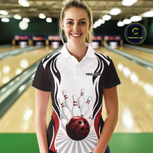 Load image into Gallery viewer, Front view of a female model inside a bowling center wearing a white, black, and red bowling polo shirt with bowling ball knocking down pins artwork.