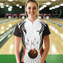 Load image into Gallery viewer, Front view of a female model in a bowling venue wearing a white, black, and orange bowling quarter-zip shirt featuring bowling-themed graphics with a bowling ball and pins.