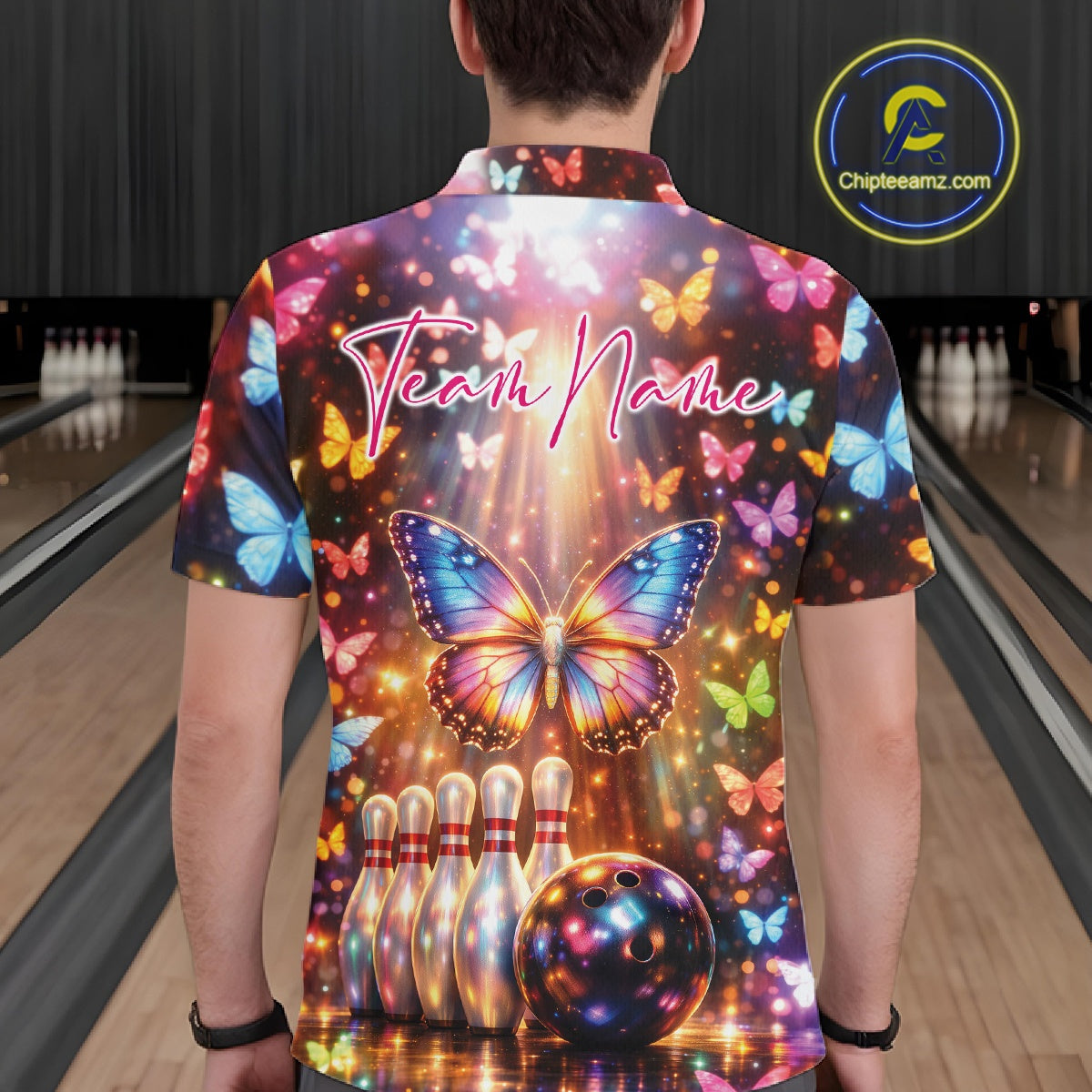 Back view of a male model in a bowling polo shirt decorated with colorful butterflies, bowling pins, bowling ball graphics, and shimmering accents.
