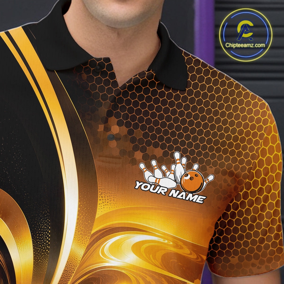 Close-up of the left chest on a bowling polo shirt featuring glossy gold and black bowling ball and pins artwork.