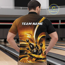 Load image into Gallery viewer, Front view of a male model at a bowling lane wearing a bowling quarter-zip shirt with glossy gold and black bowling ball and pins artwork.