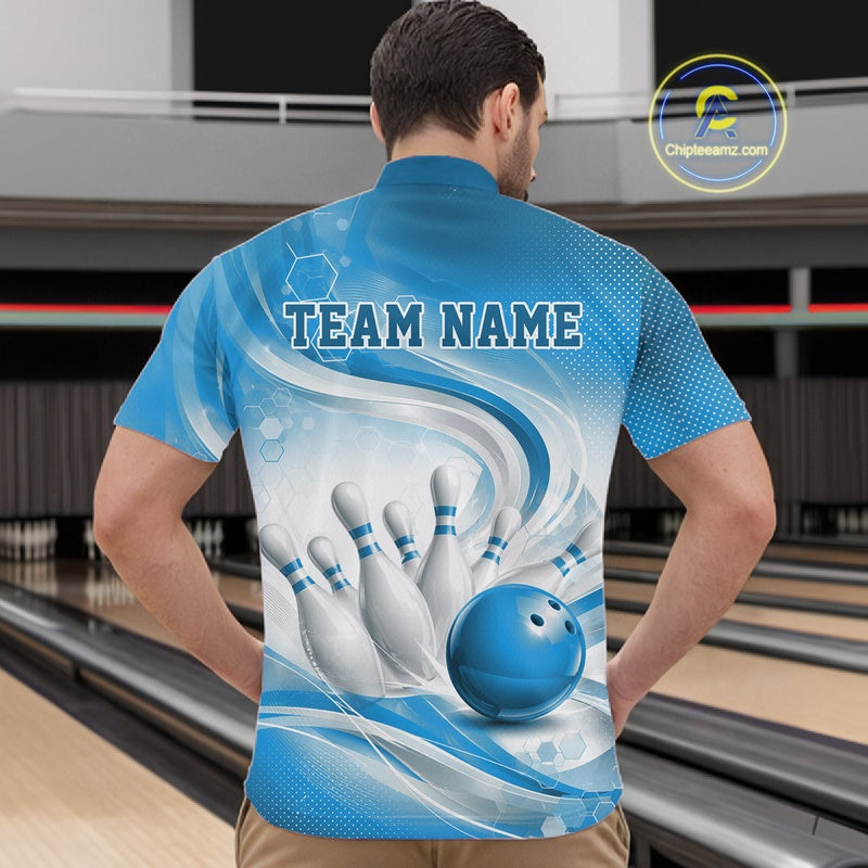 Male model standing in a bowling lane wearing a white and blue bowling quarter-zip shirt featuring abstract wave lines and a glossy bowling ball striking pins on the front.
