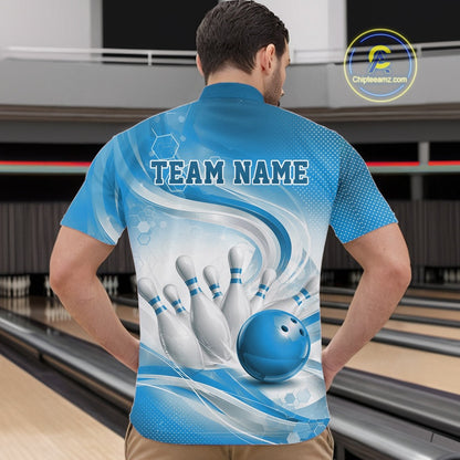 Male model standing in a bowling lane wearing a white and blue bowling quarter-zip shirt featuring abstract wave lines and a glossy bowling ball striking pins on the front.