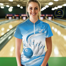 Load image into Gallery viewer, Female model standing in a bowling lane wearing a white and blue bowling quarter-zip shirt featuring abstract wave lines and a glossy bowling ball striking pins on the front.