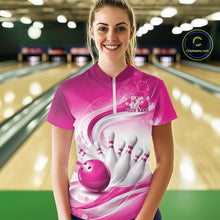 Load image into Gallery viewer, Female model standing in a bowling lane wearing a white and pink bowling quarter-zip shirt featuring abstract wave lines and a glossy bowling ball striking pins on the front.