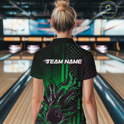 Back view of a female model in a bowling center wearing a black and green polo showcasing a bowling action motif with flames.