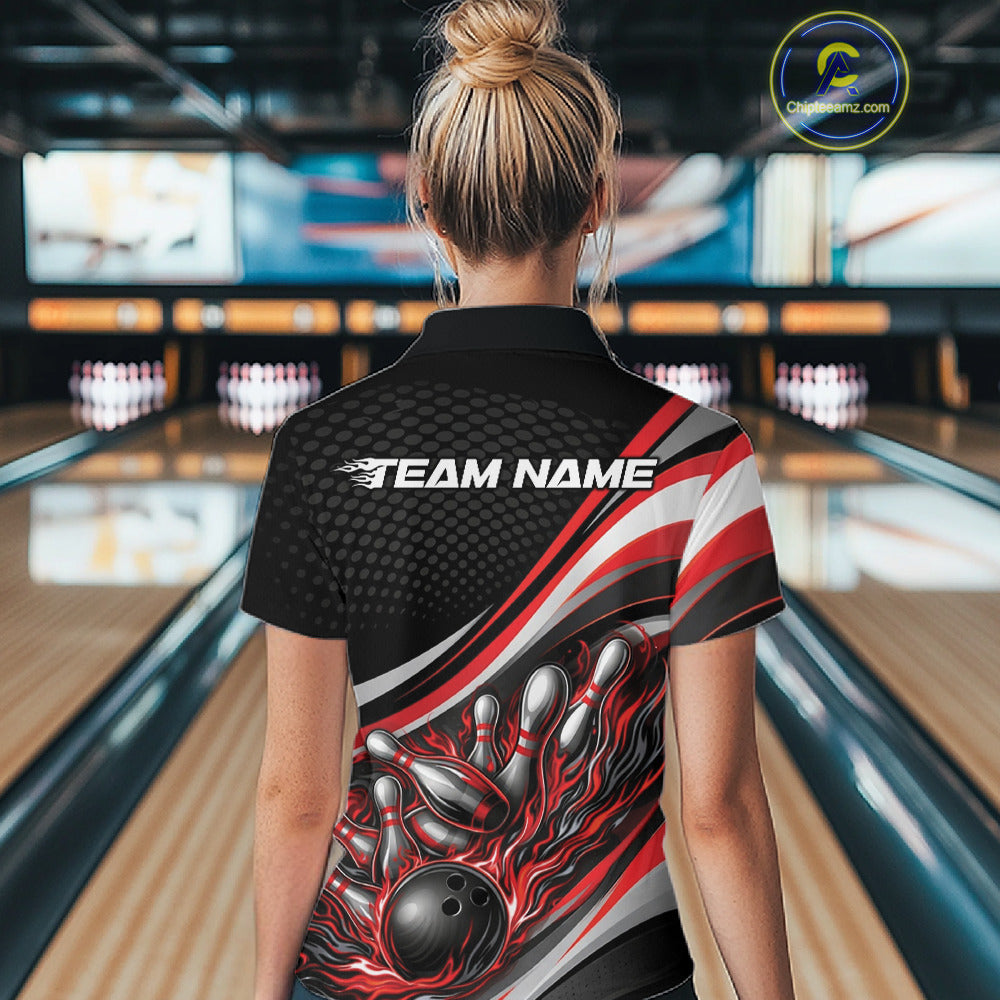 Back view of a female model in a bowling lane wearing a black and red quarter-zip shirt, flame bowling ball knocking down pins across the design.