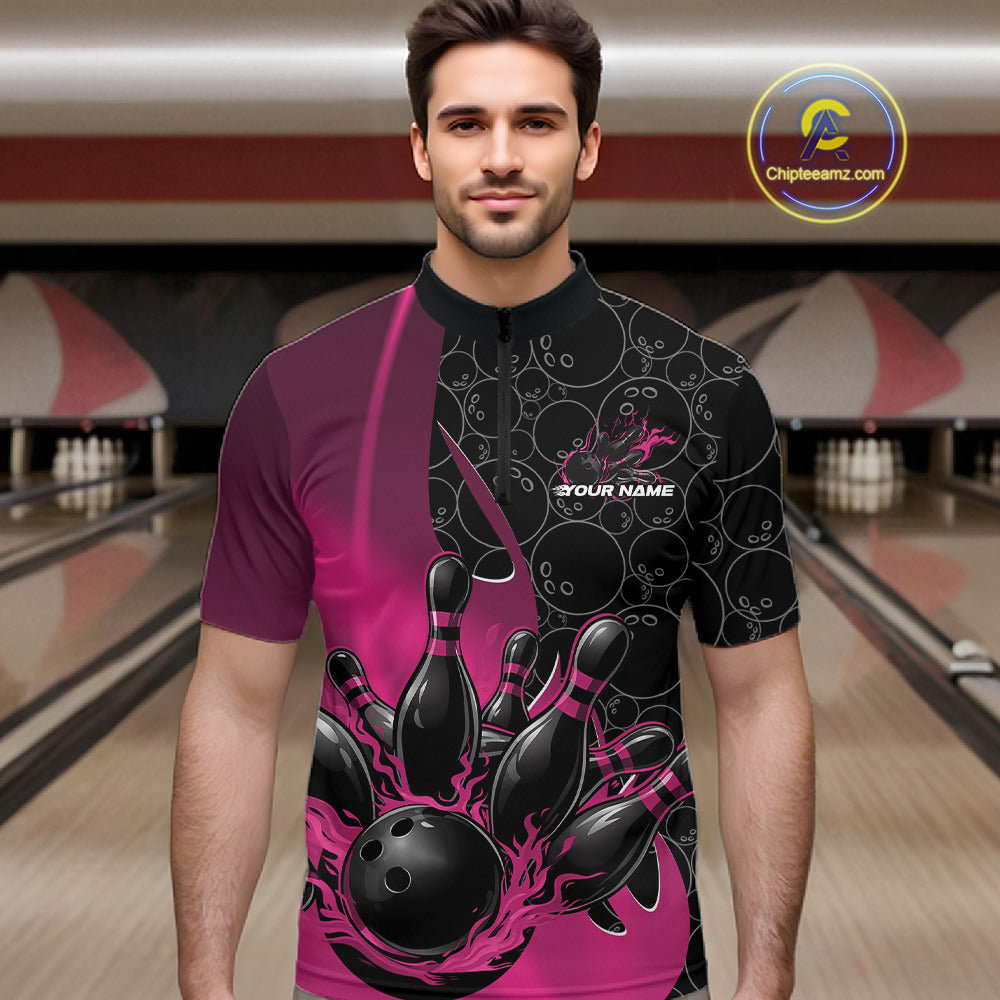 Male model front view at bowling lane wearing black and pink quarter zip shirt with flaming bowling ball pattern and dynamic gradient artwork striking pins