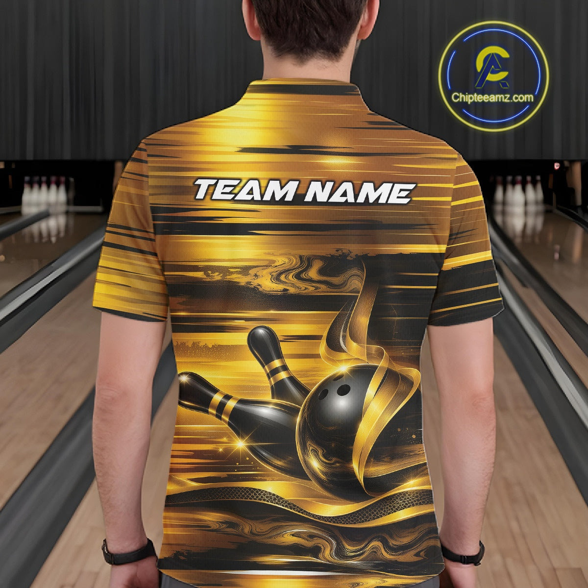Back view of a male model inside a bowling center wearing a bowling polo shirt with glossy gold and black bowling ball and pins artwork.