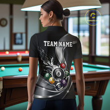 Load image into Gallery viewer, Back view of a female model in a black and silver billiard polo featuring metallic ribbons, a dark honeycomb pattern, and a flaming 8-ball