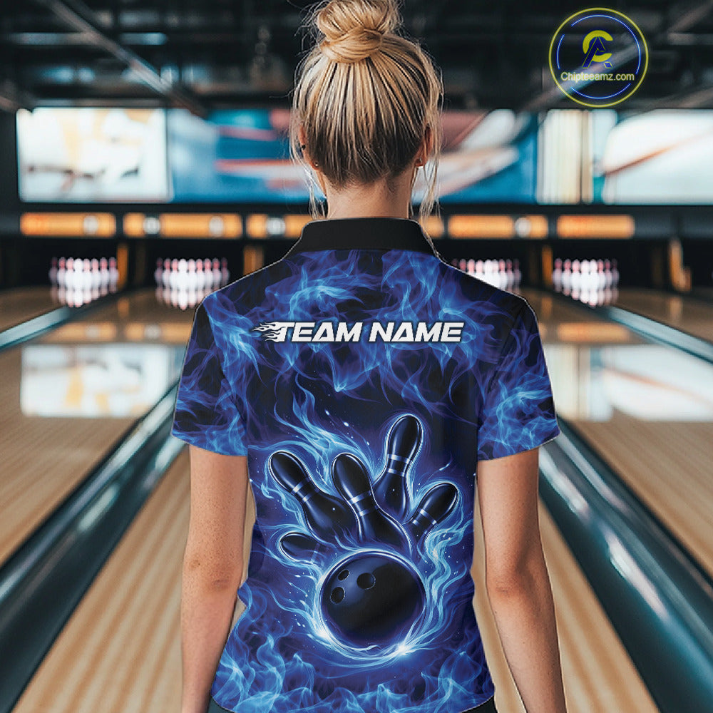 Back view of a blue womens bowling polo displaying a bowling ball encircled by flames.