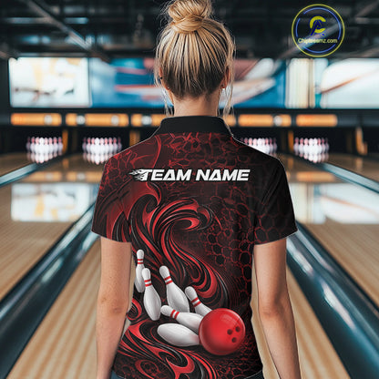 Back view of a female model wearing a black and red bowling polo shirt in a bowling alley featuring a tribal flame bowling ball and pins graphic