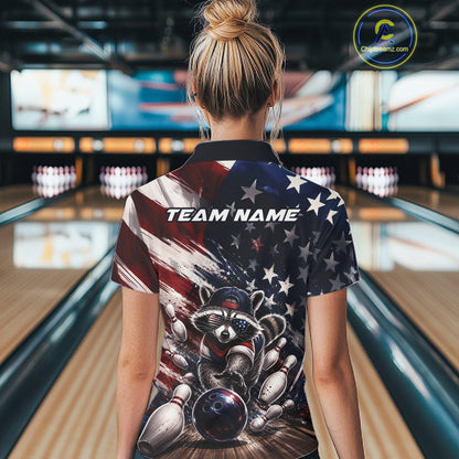 Back view of a female model at a bowling lane wearing a bowling polo shirt featuring a raccoon in patriotic sunglasses rolling a bowling ball through scattered pins with a distressed American flag backdrop.