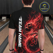 Load image into Gallery viewer, Back view of a male model wearing a black bowling polo shirt in a bowling alley featuring a skull clutching a bowling ball with swirling red energy flames