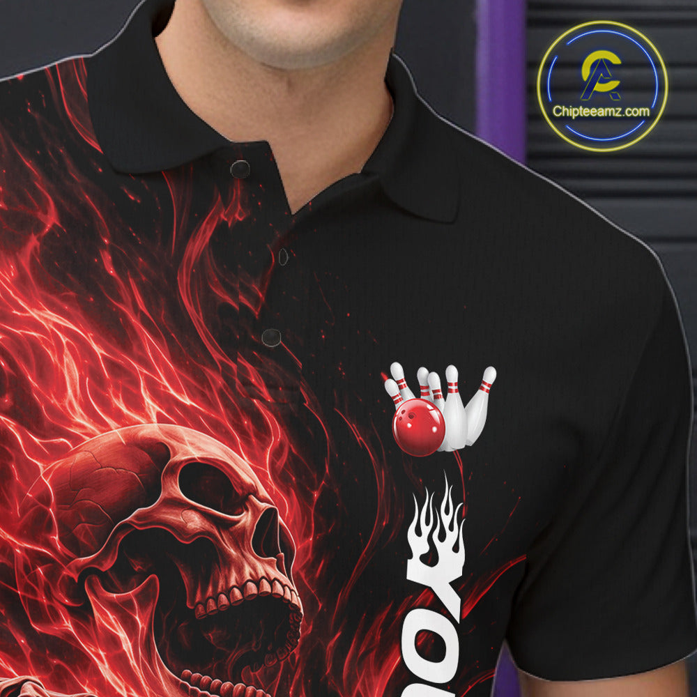 Close-up of the left chest on a black bowling polo shirt featuring a skull clutching a bowling ball engulfed in swirling red energy flames