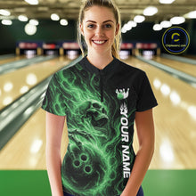 Load image into Gallery viewer, Female model wearing a black bowling quarter-zip shirt in a bowling alley featuring a skull clutching a bowling ball surrounded by swirling green energy flames