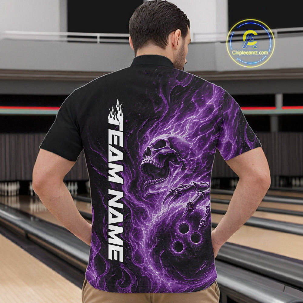 Male model wearing a black bowling quarter-zip shirt in a bowling alley featuring a skull clutching a bowling ball surrounded by swirling purple energy flames