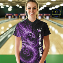 Load image into Gallery viewer, Female model wearing a black bowling quarter-zip shirt in a bowling alley featuring a skull clutching a bowling ball surrounded by swirling purple energy flames