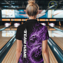 Load image into Gallery viewer, Back view of a female bowler in a bowling lane wearing a black bowling quarter-zip shirt with a purple energy-flame skull clutching a bowling ball