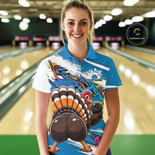 Load image into Gallery viewer, Front view of a female model wearing a blue custom bowling polo shirt with a funny graffiti turkey holding a bowling ball, paint splatter accents, and a personalized name in a bowling alley.