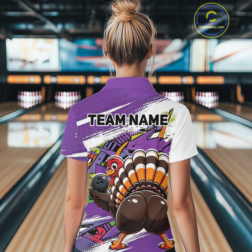 Back view of a female model in a bowling alley wearing a purple custom quarter zip bowling shirt with a funny graffiti turkey holding a bowling ball, paint splatter accents, and a personalized name.