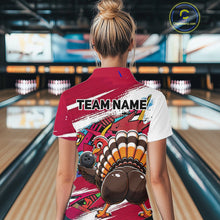 Load image into Gallery viewer, Back view of a female model wearing a red custom bowling polo shirt with a funny graffiti turkey holding a bowling ball, paint splatter accents, and a personalized name in a bowling alley.
