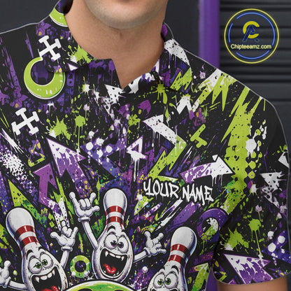 Close-up view of the left chest on a green and purple bowling polo shirt showcasing a mischievous green monster bowling ball with sharp teeth, a purple tongue, playful hand gesture, and cheerful cartoon bowling pins.
