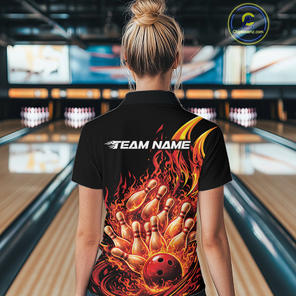 Back view female model in bowling lane wearing black and red quarter zip featuring flaming bowling ball striking pins with vivid fiery action graphics.