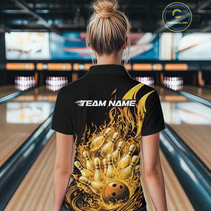 Back view in bowling lane showing female model wearing black and yellow bowling quarter zip featuring flaming bowling ball striking pins with fiery action graphics.