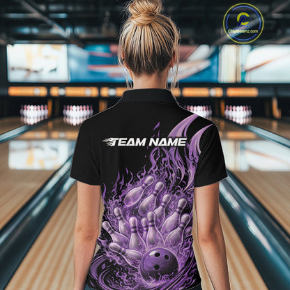 Female model seen from back in a bowling lane wearing a black and purple quarter zip shirt featuring fiery bowling ball crashing through pins with blazing flame artwork.
