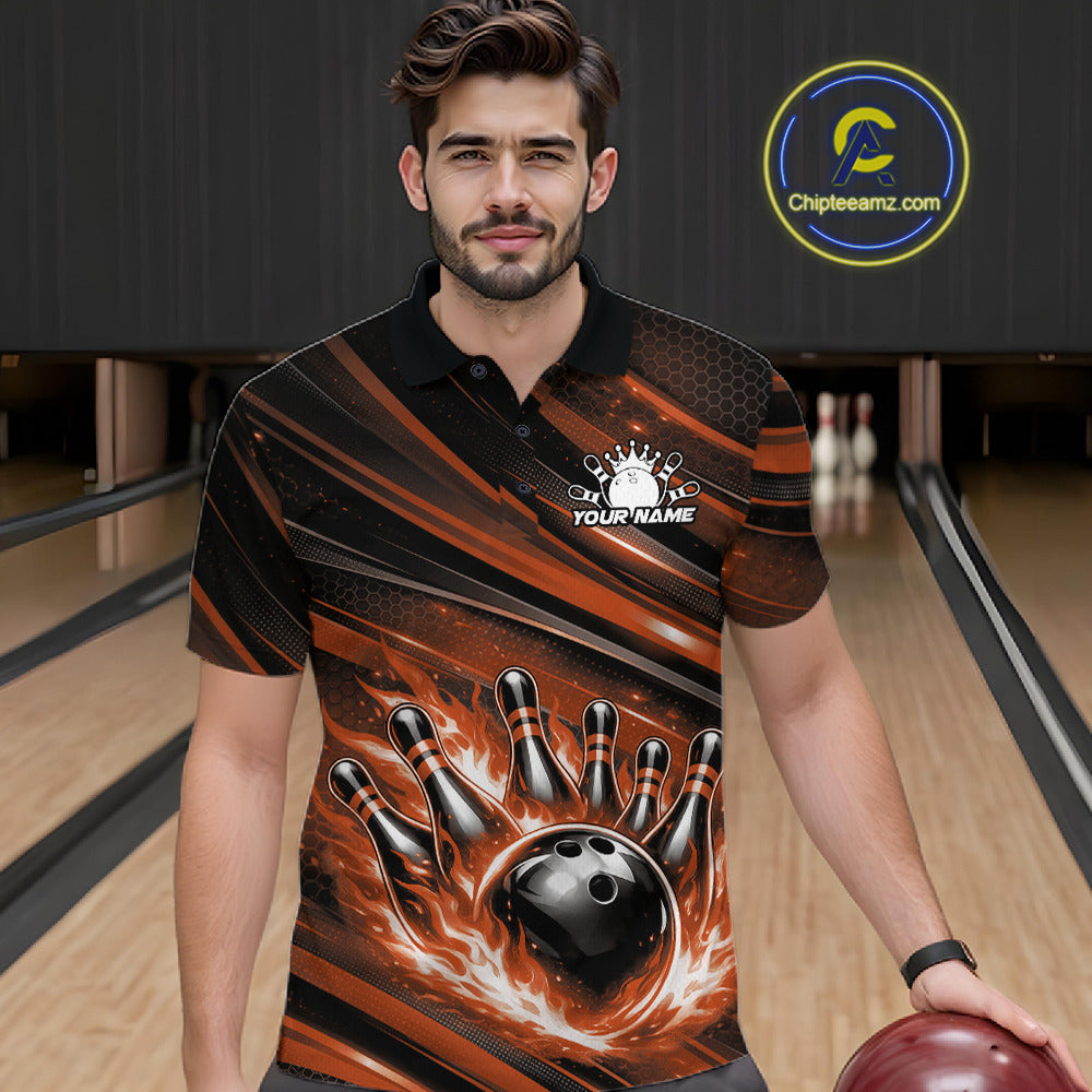 Male model at a bowling lane wearing a black and orange bowling polo shirt with flaming bowling strike artwork and energetic stripe details.