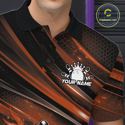Close-up of the left chest on a black and orange bowling polo shirt featuring a fiery bowling ball striking pins with abstract accents.