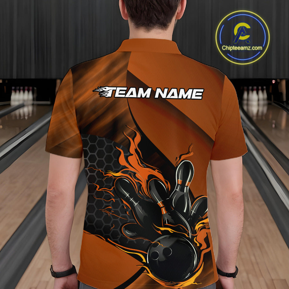 Back view of a male model in a bowling center wearing a black and orange polo shirt featuring a flaming bowling strike scene.