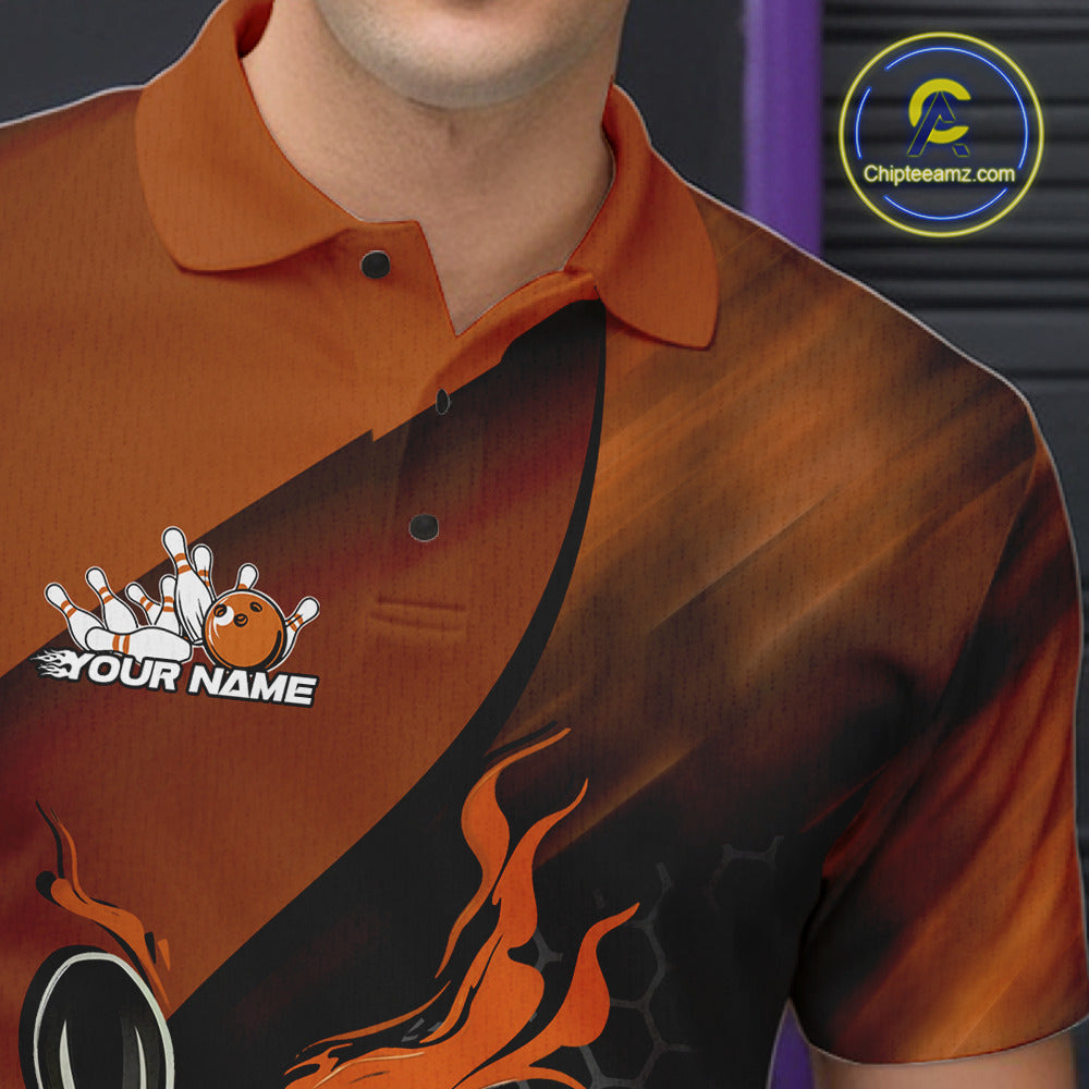 Close-up of the left chest area on a black and orange bowling polo shirt featuring a flaming bowling ball and pin design with hexagon details.