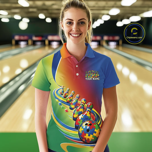 Female model in a bowling lane, front view wearing a colorful polo shirt with autism puzzle bowling ball and aligned pins illustration