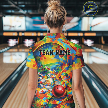 Female model in a bowling venue, back view of colorful polo shirt featuring autism puzzle bowling motif with vibrant tones