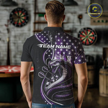 Load image into Gallery viewer, Male model showcasing the back design of a custom purple and black stars and stripes patriotic cobra snake men's dart polo shirt with a customizable "TEAM NAME" text template in an indoor setting.