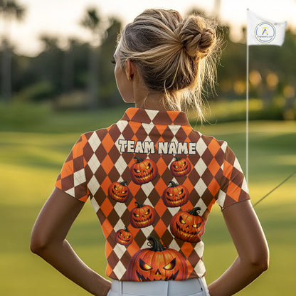 A woman seen from behind wearing a short-sleeve collared polo shirt with an orange and cream harlequin pattern, pumpkin graphics, and 'TEAM NAME' printed across the back, standing on a golf course.