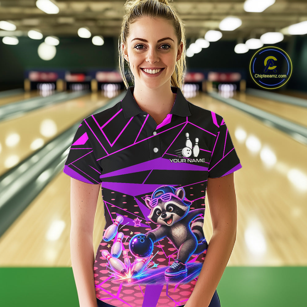 Person wearing a colorful bowling shirt with a raccoon design in a bowling alley.