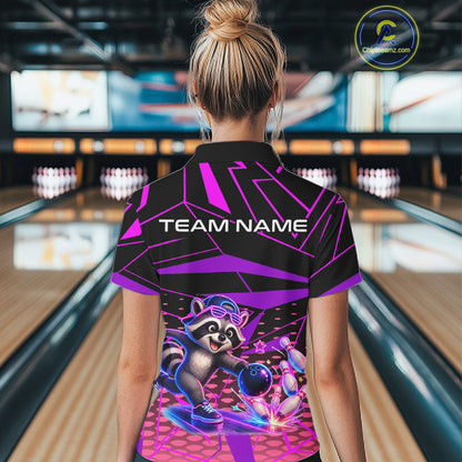 Person wearing a bowling shirt with a raccoon graphic and 'TEAM NAME' text in a bowling alley.