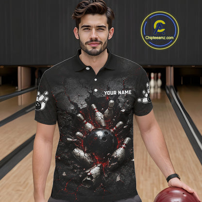 Man wearing a black bowling-themed shirt with a graphic design in a bowling alley.