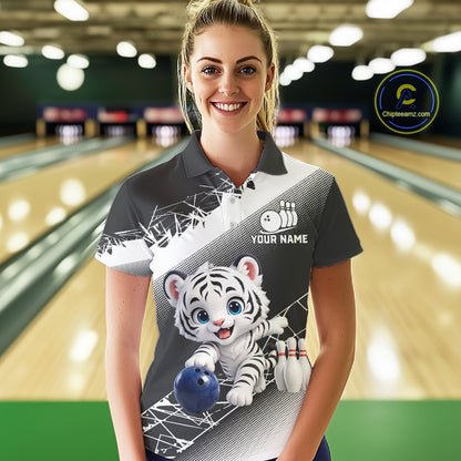 Woman wearing a bowling shirt with a tiger design in a bowling alley.