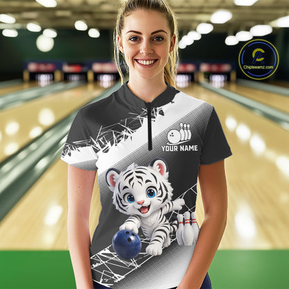 Woman wearing a bowling shirt with a tiger design in a bowling alley.