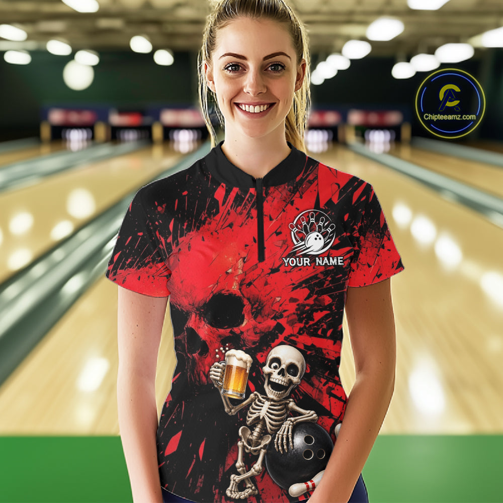 Person wearing a red and black bowling shirt with a skeleton design in a bowling alley.