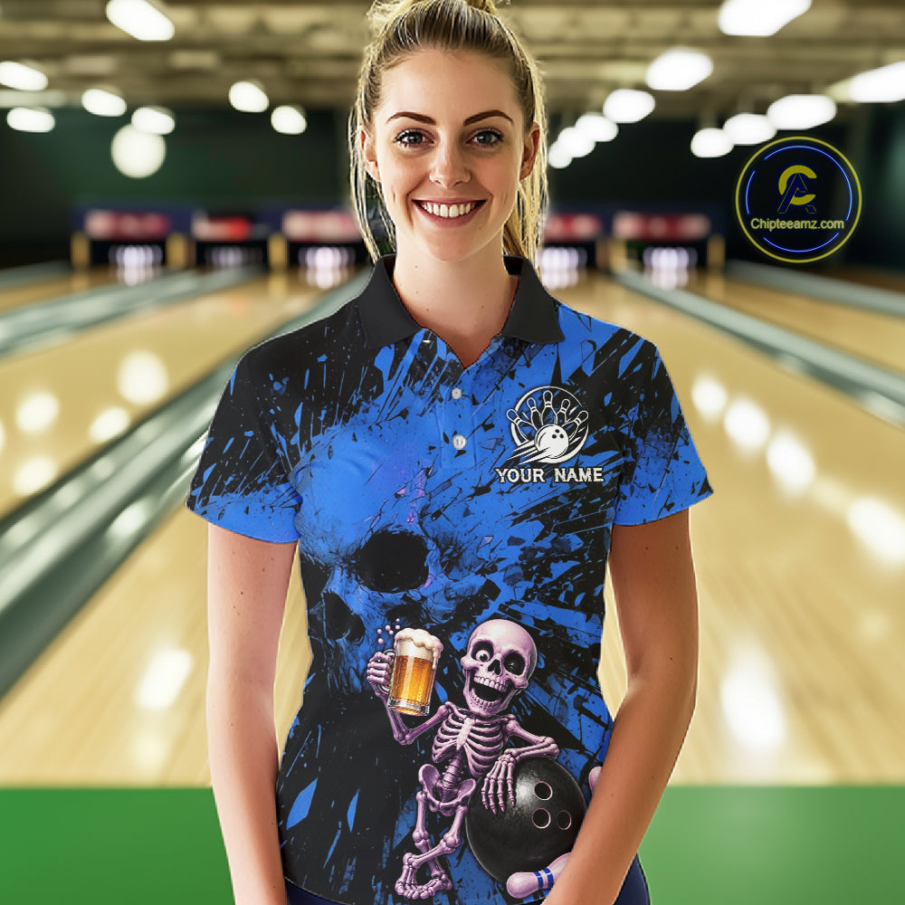 Person wearing a blue and black bowling shirt with a skeleton design in a bowling alley.